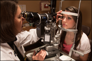 student receiving eye exam from doctor